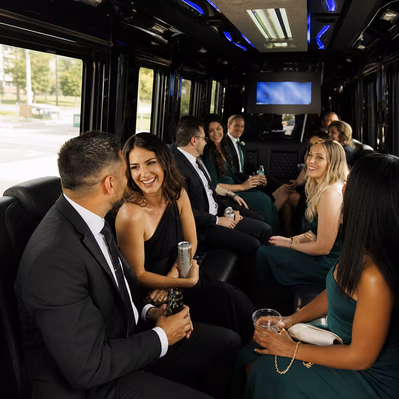 Wedding guests seated inside a Toledo party bus