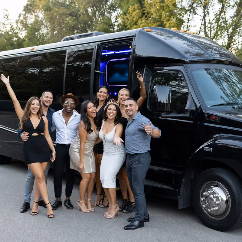 Group boarding a white charter bus for Birthday Transportation transportation in Toledo