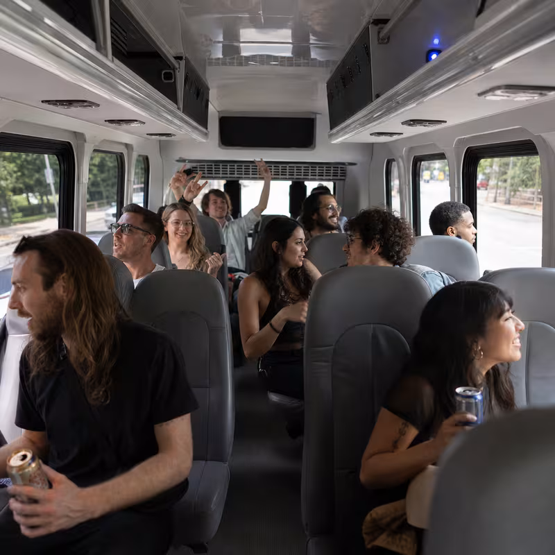 Party bus interior with wraparound leather seating and LED lighting in Toledo