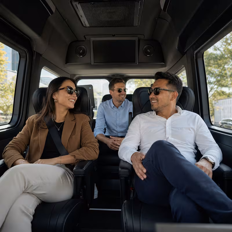 Group boarding a white charter bus for Corporate Transportation transportation in Toledo