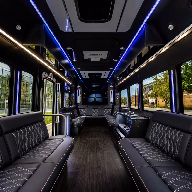 Party bus interior with wraparound leather seating and LED lighting in Toledo