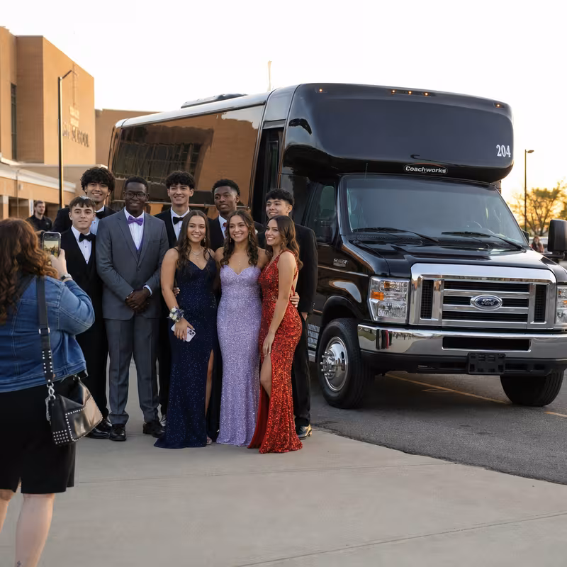 Group boarding a white charter bus for Prom & Homecoming Transportation transportation in Toledo