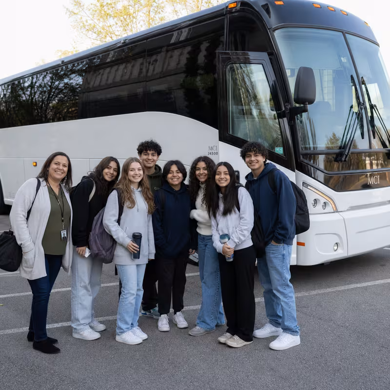 Passengers loading luggage while boarding an Toledo group shuttle