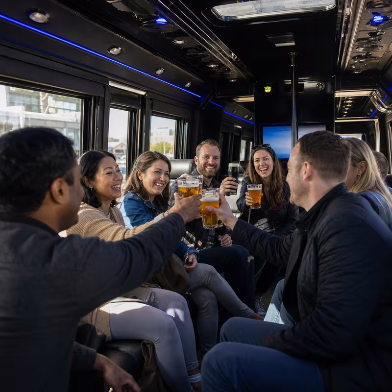 Group boarding a white charter bus for Winery & Brewery Tour Transportation transportation in Toledo