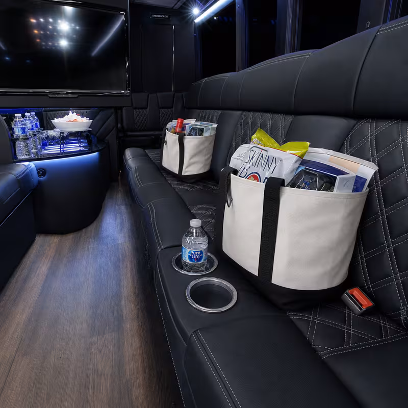 Party bus interior with wraparound leather seating and LED lighting in Toledo